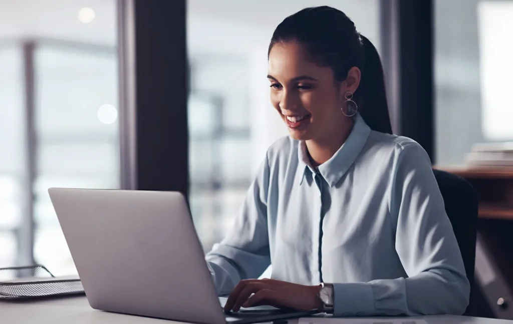 Profissional de Departamento Pessoal trabalhando no notebook no fechamento do ano de 2026